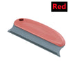 A portable lint and pet hair remover brush with a pink and gray handle and a metal comb-like blade.
