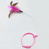 A pink feather cat teaser wand with a rotating head and bell attached to a pink handle.