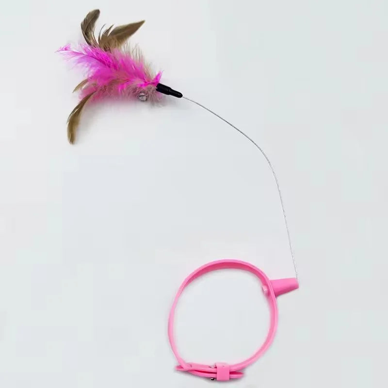 A pink feather cat teaser wand with a rotating head and bell attached to a pink handle.