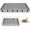 A gray PVC cage liner with black straps and a wire mesh bottom, shown alongside several guinea pigs.