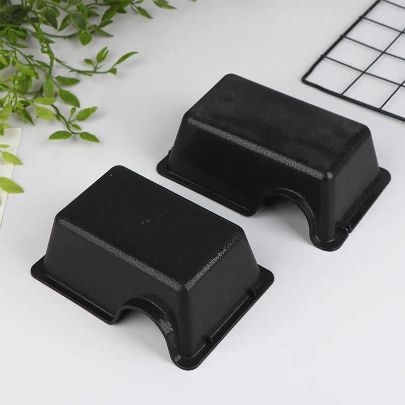 Black reptile and small animal hide box with a square grid in the background