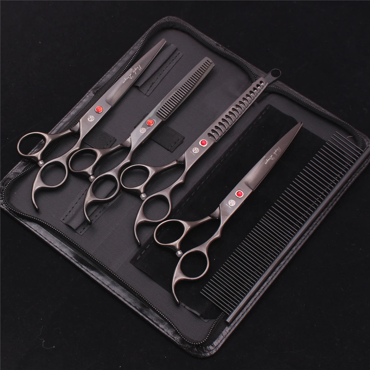 A professional stainless steel pet grooming scissors set with various blades and a comb inside a black leather case.