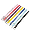 A collection of nine studded leather dog collars with metal rivets in various pastel and dark colors.