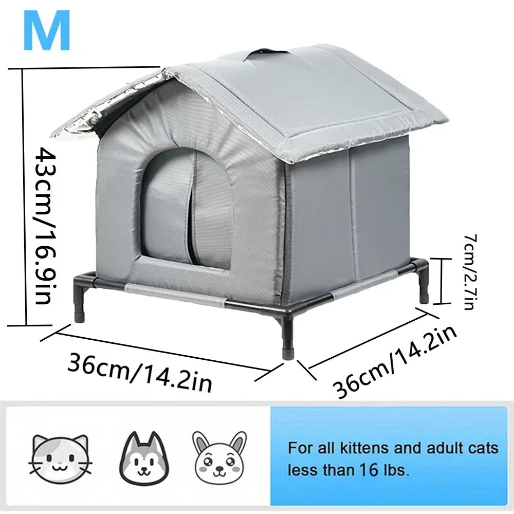 A gray heated outdoor cat shelter with a slanted roof and a metal frame, designed for kittens and adult cats less than 16 lbs