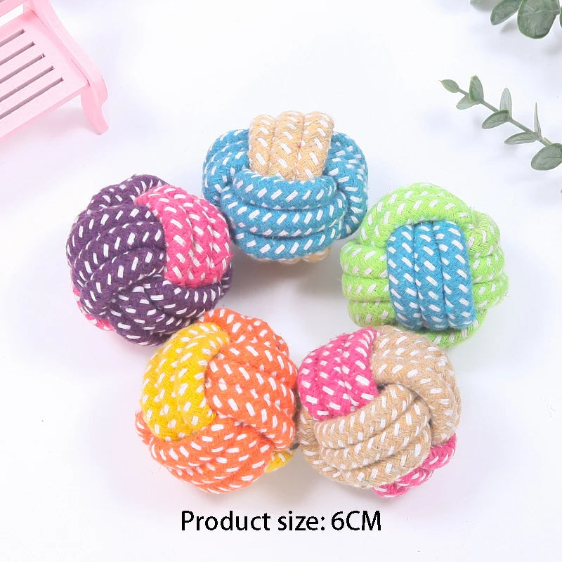 A collection of six colorful, braided cotton rope dog chew toys in various shades including purple, blue, green, and orange.