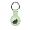 A light green silicone protective cover for an AirTag with a metal keychain ring.