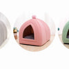 A cozy cat bed cave in light gray, pink, and green colors with a washable cushion.