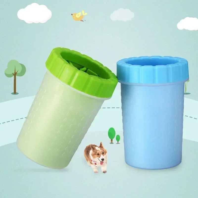 A light green silicone pet paw cleaner container next to a blue one, with a dog sitting nearby.