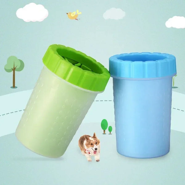 A light green silicone pet paw cleaner container next to a blue one, with a dog sitting nearby.