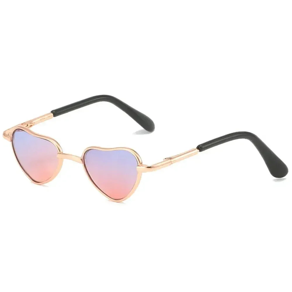 Gold-toned heart-shaped sunglasses with tinted lenses for pets