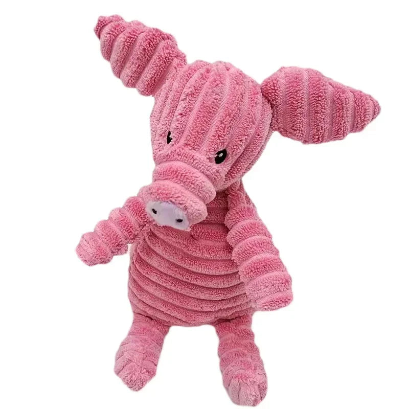 A pink corduroy squeaky dog toy shaped like a pig with textured skin.