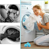 A woman is using reusable lint catchers inside a white washing machine drum to remove lint from laundry.