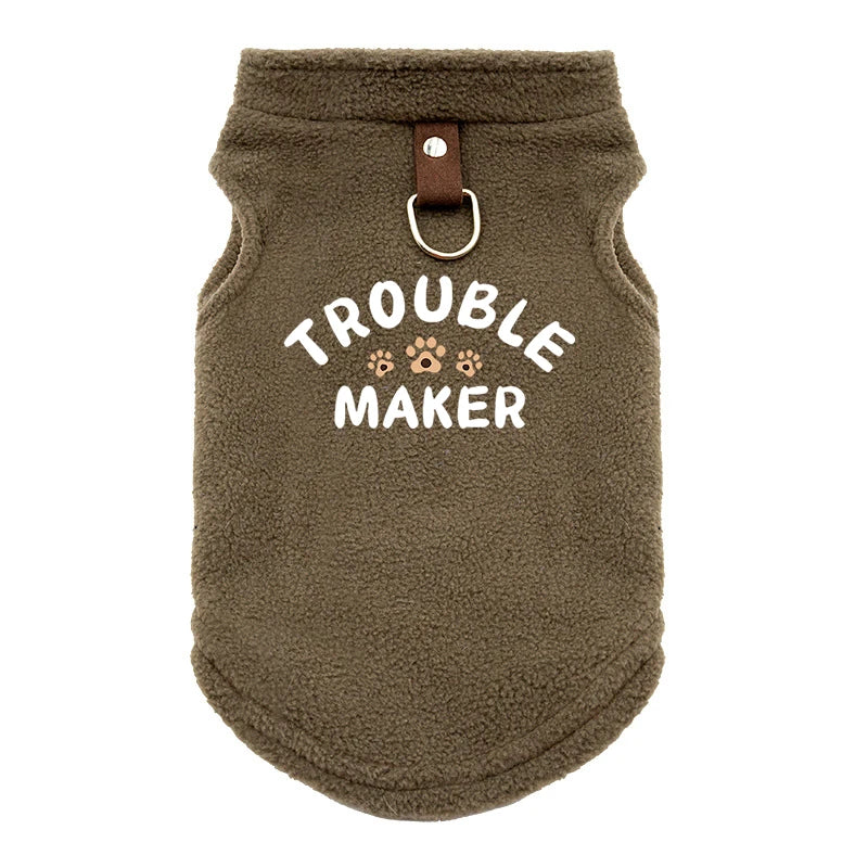 A brown, fuzzy pet jacket for dogs with the text Trouble Maker embroidered on the chest.