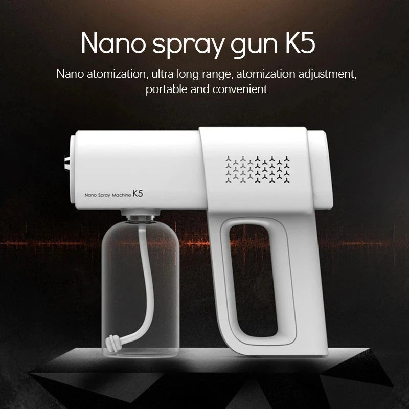 A white Nano spray gun K5 device is shown next to its clear spray bottle on a dark surface.