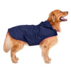 A golden retriever wearing a navy blue reflective waterproof dog raincoat.