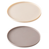 A round, light beige silicone pet feeding mat for dogs and cats.