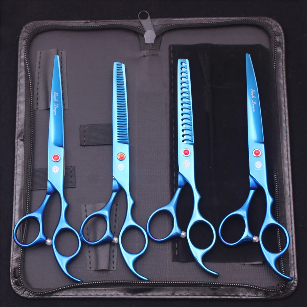 A set of professional stainless steel pet grooming scissors in blue housed in a dark protective case.