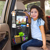 A smiling girl sits in a car backseat showing a black organizer with a tablet holder and storage pockets.