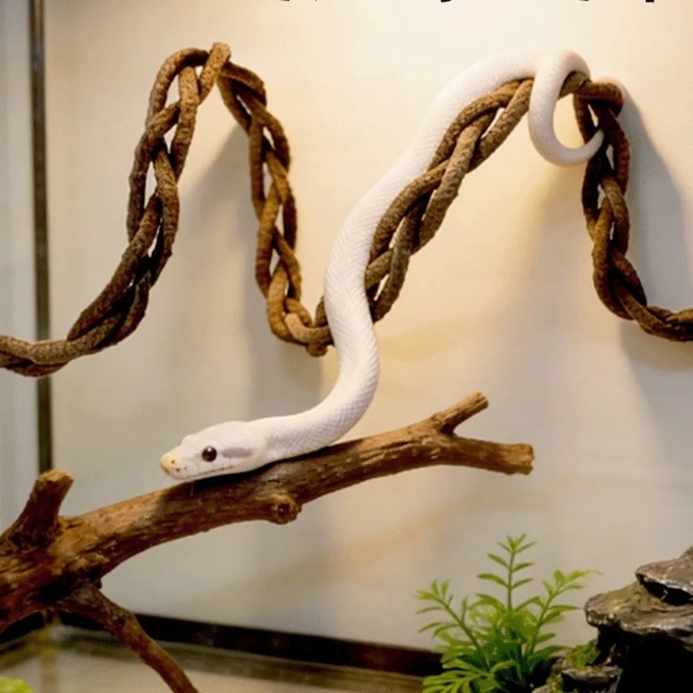 A white lizard is climbing a woven hammock suspended on a wooden branch.