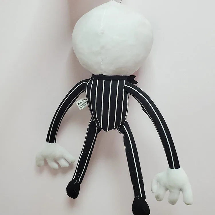 A white cartoon skeleton dog plush toy with black stripes and limbs hanging against a light background.