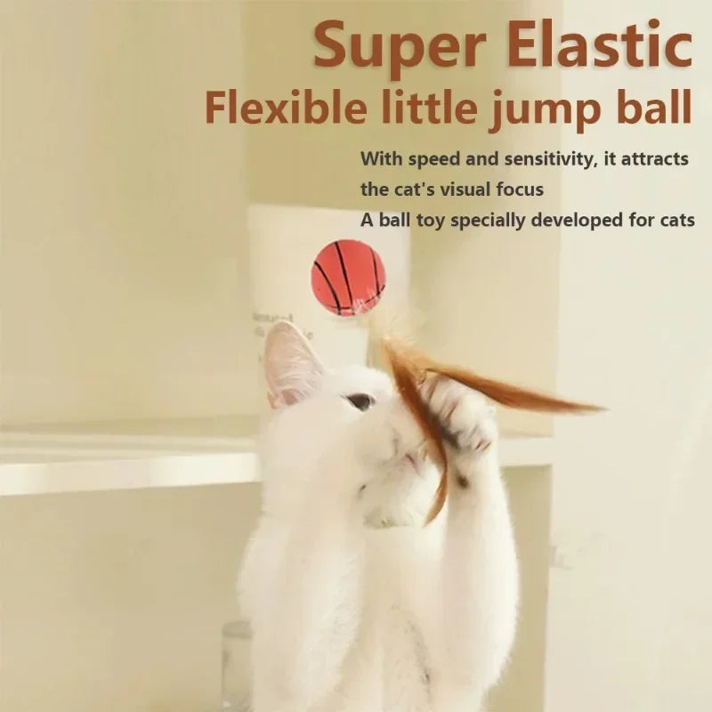 A white cat is interacting with a red ball toy designed for cats.