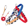 A set of adjustable dog harness and leash featuring red, blue, and yellow straps with a black and white pattern.