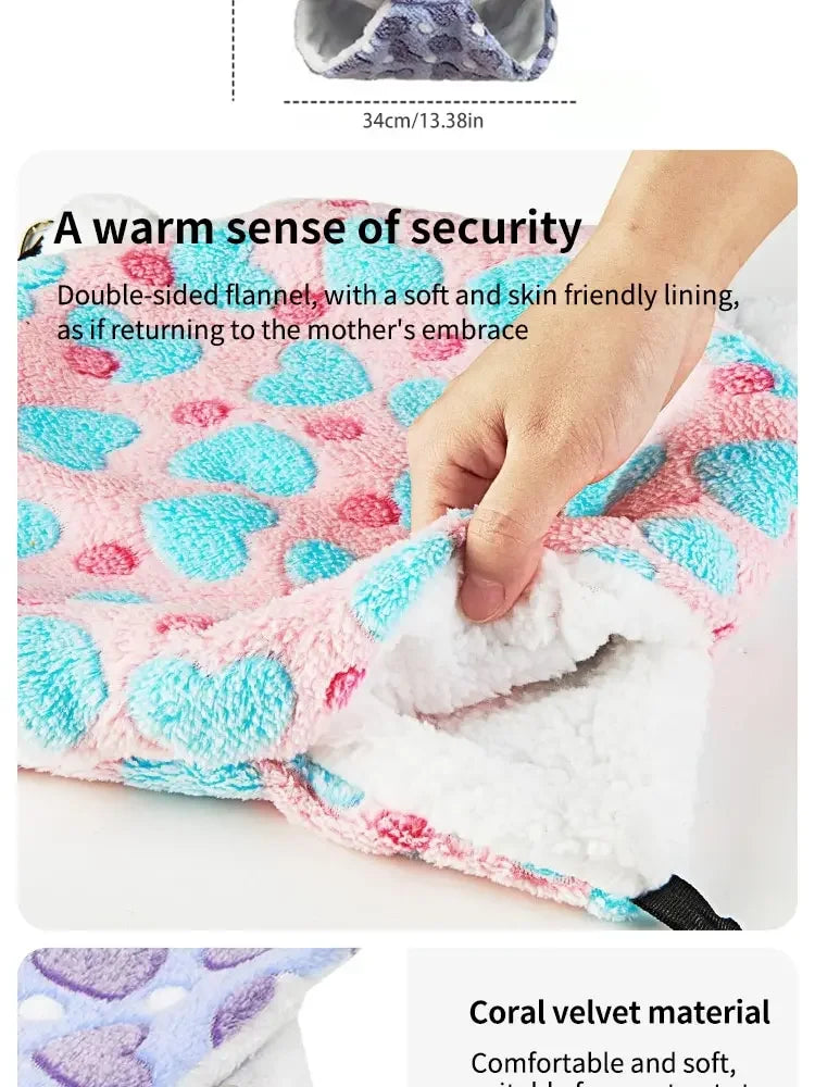 A pink and blue plush pet hammock with a soft lining designed for small animals.