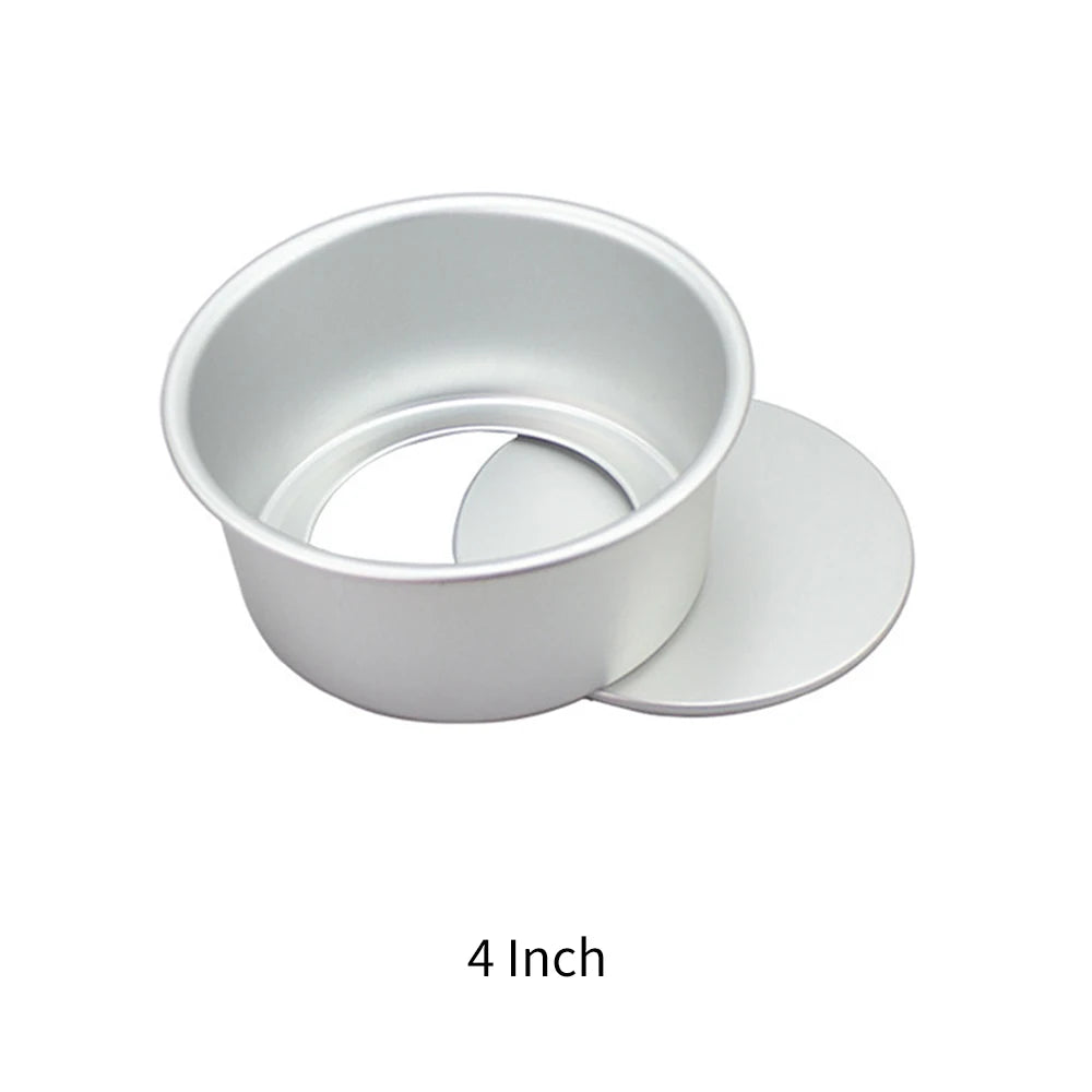 A round aluminum cake pan set consisting of a ring and a separate disc, shown in white.