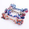 A bundle of colorful, braided cotton rope dog chew toys with various shades of blue, pink, orange, and gray.