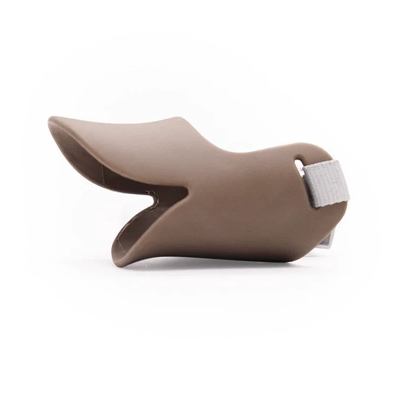 A tan silicone dog muzzle designed for small to medium dogs, featuring a flexible design and a padded strap.