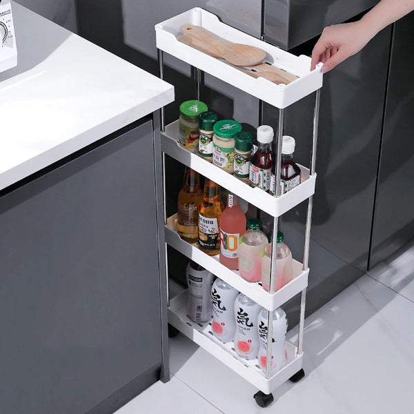 A white 3/4 tier mobile storage rack holding various glass and plastic bottles and wooden utensils in a kitchen setting.