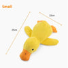 A small yellow plush duck toy with an orange beak and feet, shown next to a measurement guide.