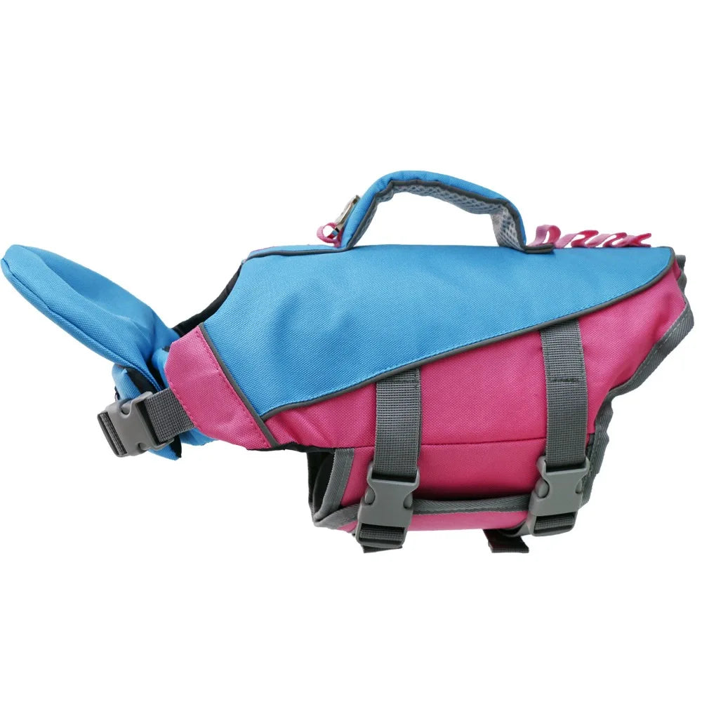A brightly colored dog life jacket featuring blue and pink panels with a handle.