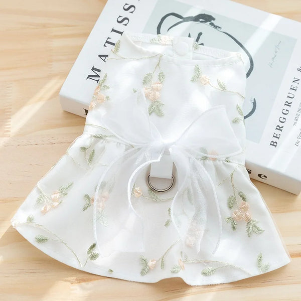 White summer dress for a dog featuring floral embroidery and a bow detail