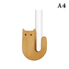 A wooden cat-shaped vase with a white cylindrical opening.