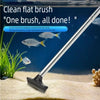 A silver telescopic flat brush is shown cleaning sand from the bottom of an aquarium tank.