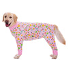 A golden Labrador dog wearing a pink cartoon print cotton pajama top.