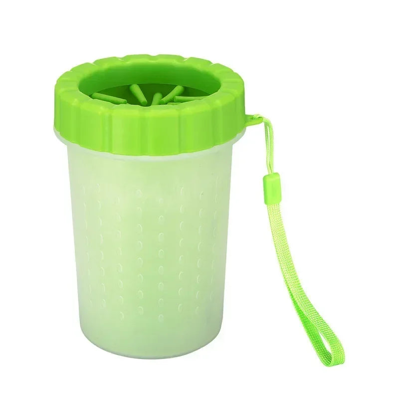 A lime green silicone pet paw cleaner container with a green lid and a hanging loop.