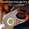 A hand is holding an orange and white double-sided RGB light ring device for pet safety.