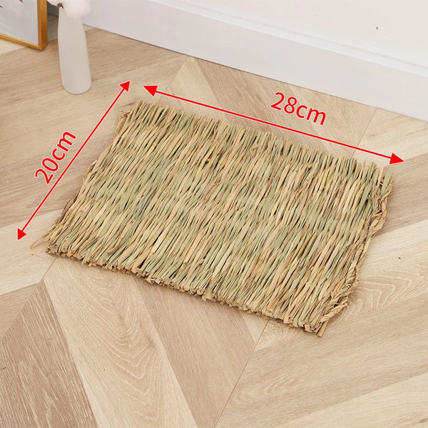 A rectangular mat woven from natural straw placed on a light wood floor.