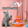 An orange interactive cat toy tower with multiple levels and a feather, sitting next to a gray cat.