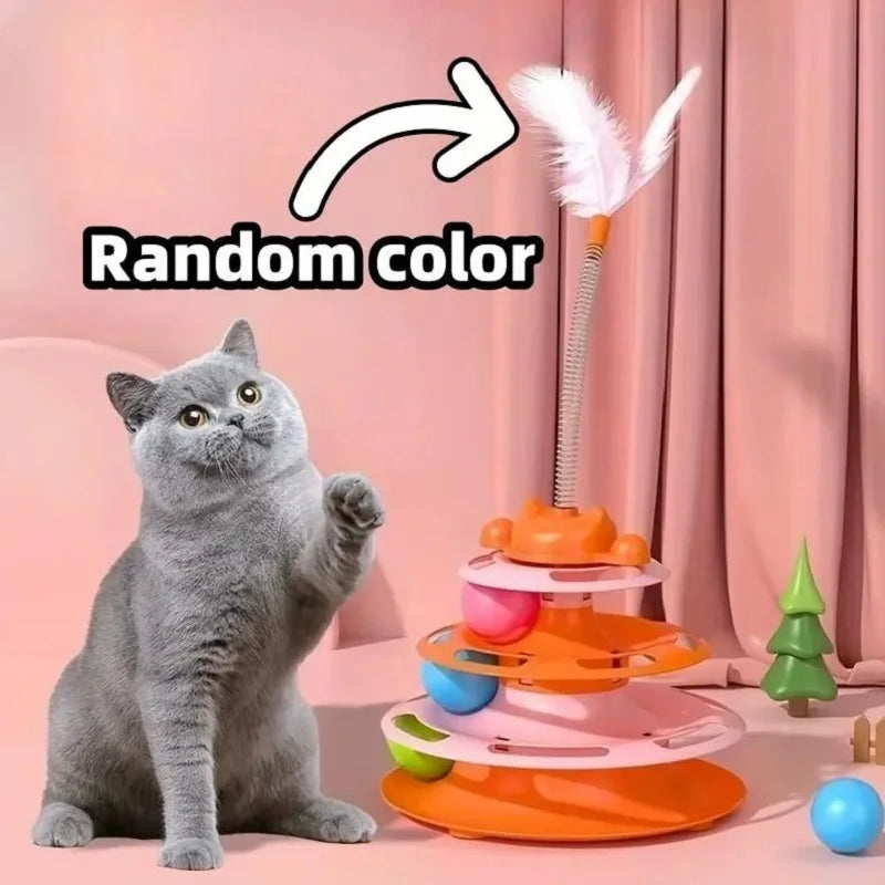 An orange interactive cat toy tower with multiple levels and a feather, sitting next to a gray cat.