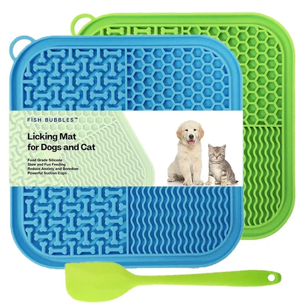 A blue silicone licking mat for dogs and cats with suction cups and a green silicone spoon.