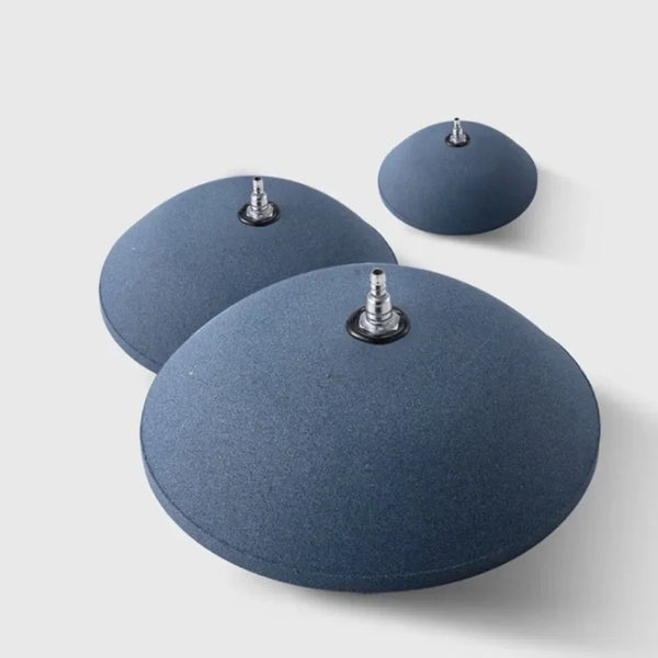 A dark blue aquarium air stone disc for fish tank oxygenation, shown in various angles.