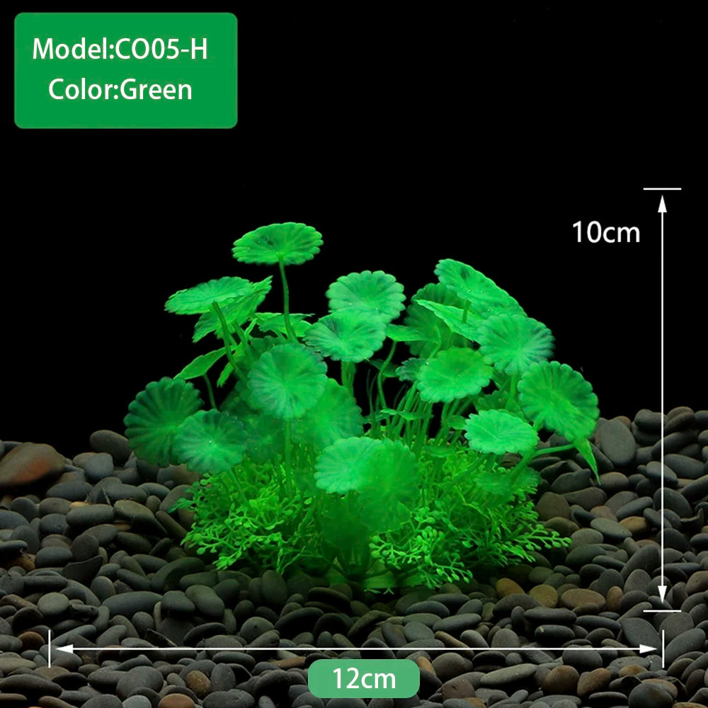 Green artificial aquarium plants growing in dark gravel