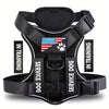 Black harness for a service dog with an American flag patch and in training label