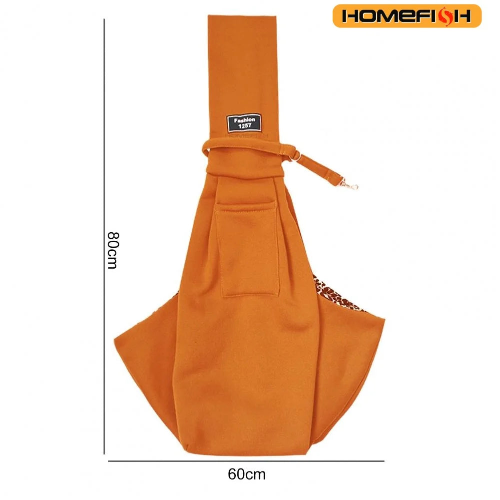 Orange adjustable crossbody dog sling carrier with a flap and decorative trim