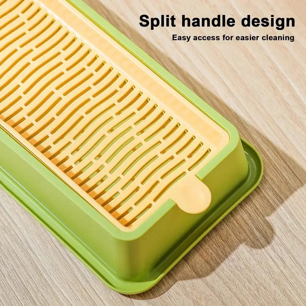 A yellow layered cat grass growing kit with a split handle design resting on a wooden surface.
