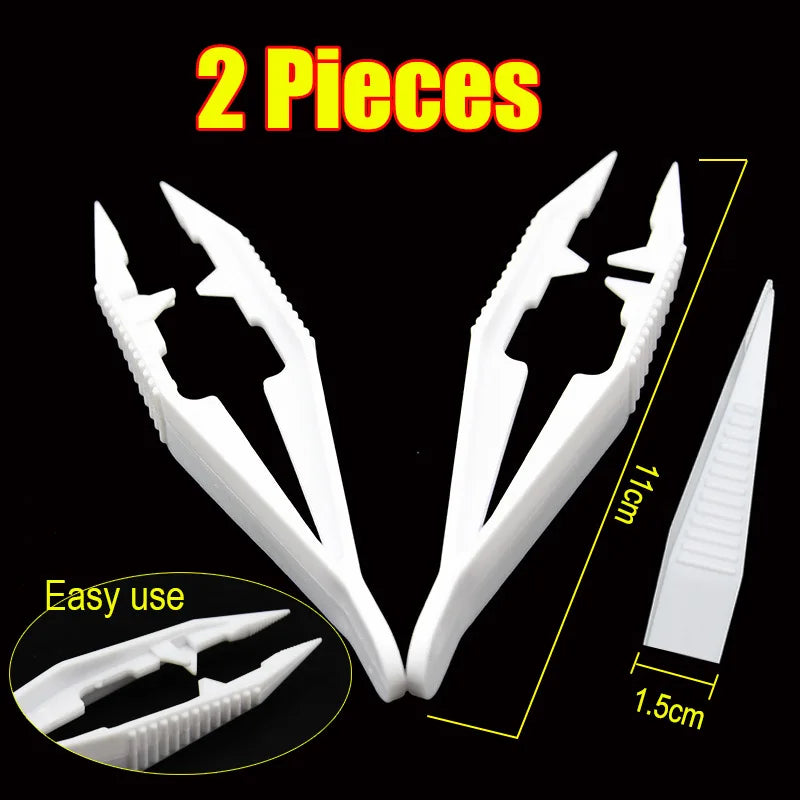 Two white precision tweezers pieces shown with a scale for size comparison.