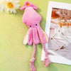 A pink squeaky octopus plush toy with yellow accents is displayed next to a framed photo.